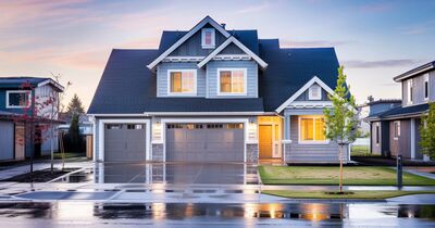 A newly completed two-story suburban house seen from the street on an overcast Oregon morning