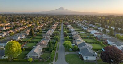 Aerial drone view of a residential neighborhood in the Portland Oregon metro area showing rows of well-maintained homes